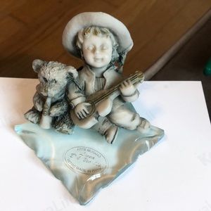 Little boy with his guitar and bear